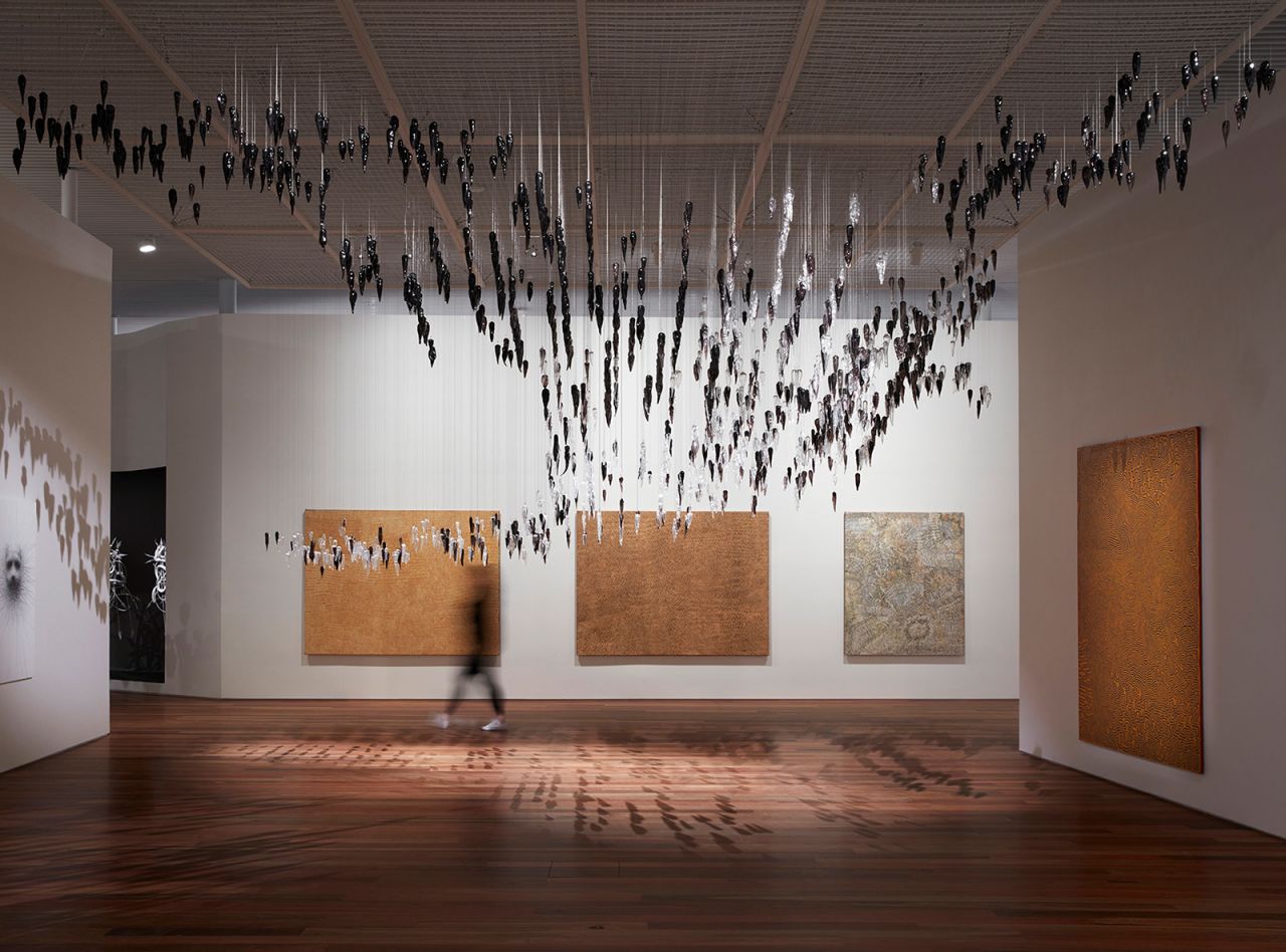 Installation view of the Yiribana Gallery, featuring works by Aboriginal artists (from left to right) Yukultji Napangati, Doreen Reid Nakamarra, Bobby West Tjupurrula, Ronnie Tjampitjinpa and (top) Yhonnie Scarce.