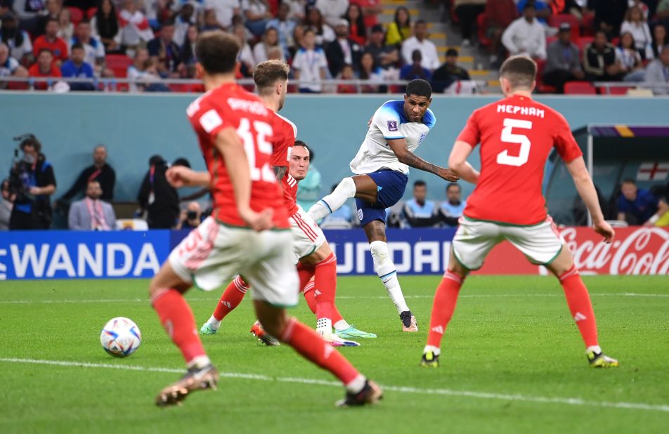 Marcus Rashford scores England's third goal against Wales. He had two goals in the match.