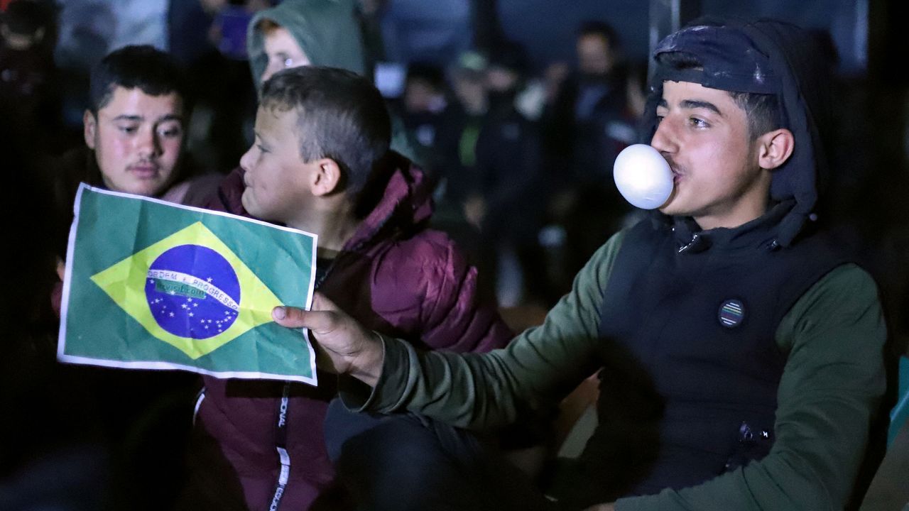 A boy shows his support for Brazil as people at the "Maram" camp for those displaced by conflict about seven kilometers from Syria's rebel-held northwestern city of Idlib watch the World Cup match between Brazil and Switzerland on Monday. 