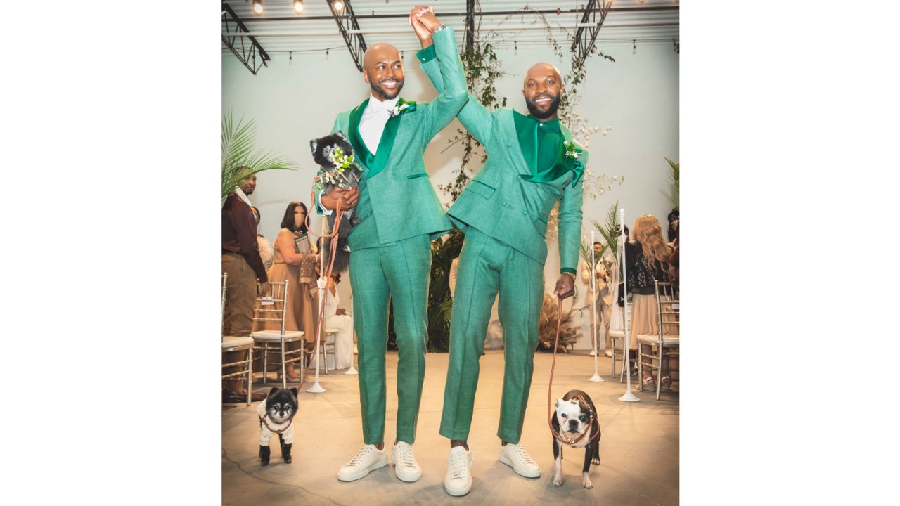 Daron and James, with their dogs, on their wedding day in 2021.