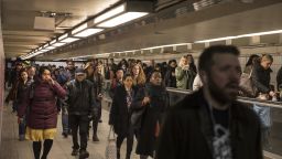 Commuters walk though the Court Square subway station in the Queens borough of New York, U.S., on Wednesday, Dec. 20, 2017. Victor J. Blue/Bloomberg via Getty Images. 
