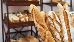 Bread baguettes in a basket in the baking shop