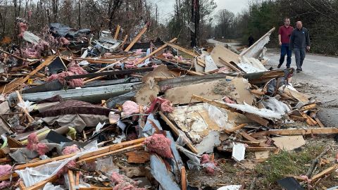 People walk through a destroyed area in Flatwood, Alabama on Wednesday. 