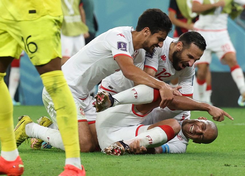 Tunisian players mob teammate Wahbi Khazri after his goal against France on November 30. Tunisia won 1-0, but it was not enough to advance to the knockout stage. France still won Group D.