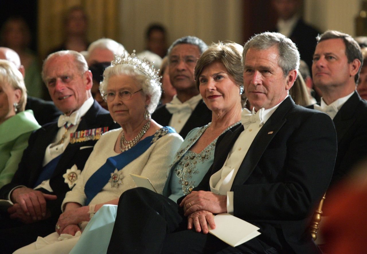 US President George W. Bush, right, sits with first lady Laura Bush, Britain's Queen Elizabeth II and Prince Philip as they listen to a performance by violinist Itzhak Perlman after a state dinner in 2007.
