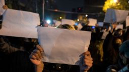 BEIJING, CHINA -NOVEMBER 27: Protesters hold up a white piece of paper against censorship as they march during a protest against Chinas strict zero COVID measures on November 27, 2022 in Beijing, China. Protesters took to the streets in multiple Chinese cities after a deadly apartment fire in Xinjiang province sparked a national outcry as many blamed COVID restrictions for the deaths. (Photo by Kevin Frayer/Getty Images)