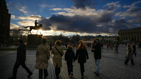 Pedestrians walk in Manezhnaya Square with the silhouetted statue of Soviet Marshal Georgy Zhukov in the background on November 13. 