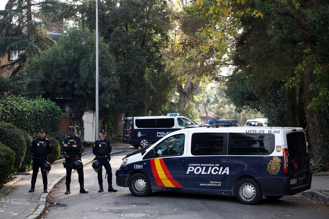 Police stand near the Ukrainian embassy in Madrid after a letter bomb explosion on November 30, 2022.