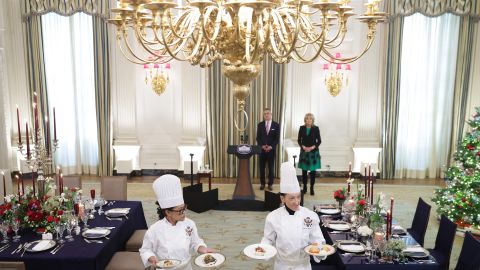 US First Lady Jill Biden and White House Social Secretary Carlos Elizondo (back) look on as White House Executive Chef Cris Comerford (L) and White House Executive Pastry Chef Susie Morrison (R) present the menu during a media preview ahead of the State Dinner.