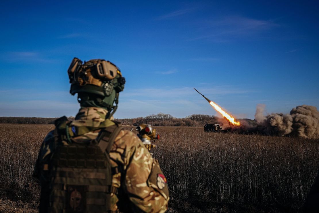 A Ukrainian soldier watches a self-propelled 220 mm multiple rocket launcher "Bureviy" firing towards Russian positions in eastern Ukraine on November 29, 2022