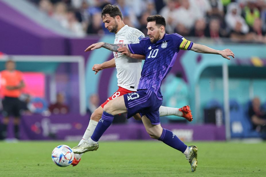 Messi and Poland's Bartosz Bereszynski compete for the ball.