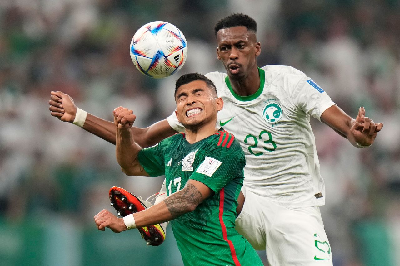 Mexico's Orbelín Pineda, left, and Saudi Arabia's Mohamed Kanno go for a header during their match on November 30. Mexico won 2-1.