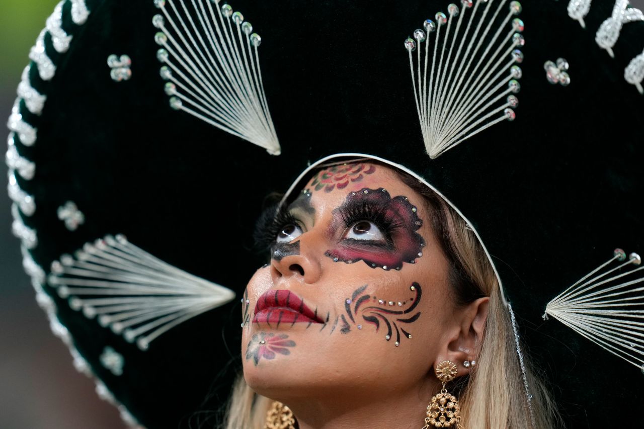 A fan wears La Catrina-style makeup at the start of the Mexico-Saudi Arabia match.