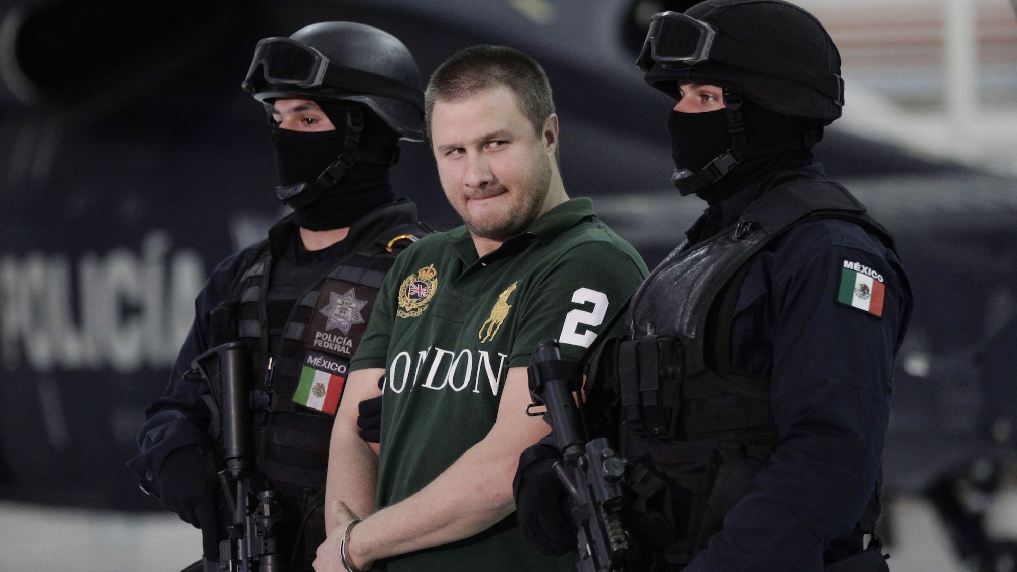 Edgar "La Barbie" Valdez Villareal is escorted by Mexican federal police during a news conference at the federal police center in Mexico City in August 2010.