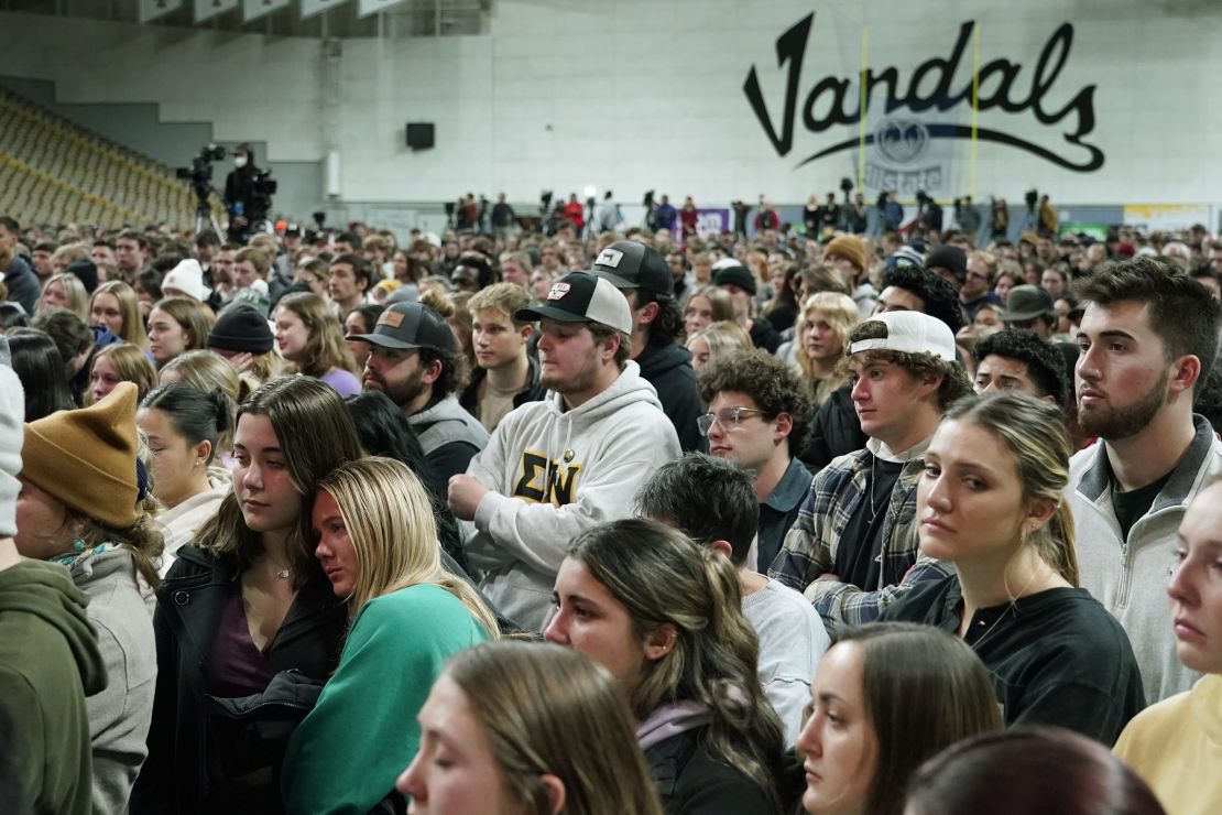 People attending a November 30 vigil for the four University of Idaho students stand in the Kibbie Dome as family members talk about their loved ones in Moscow, Idaho.