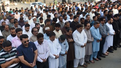 Mourners offer absentia funeral prayers in Karachi on October 27, 2022, for Sharif.