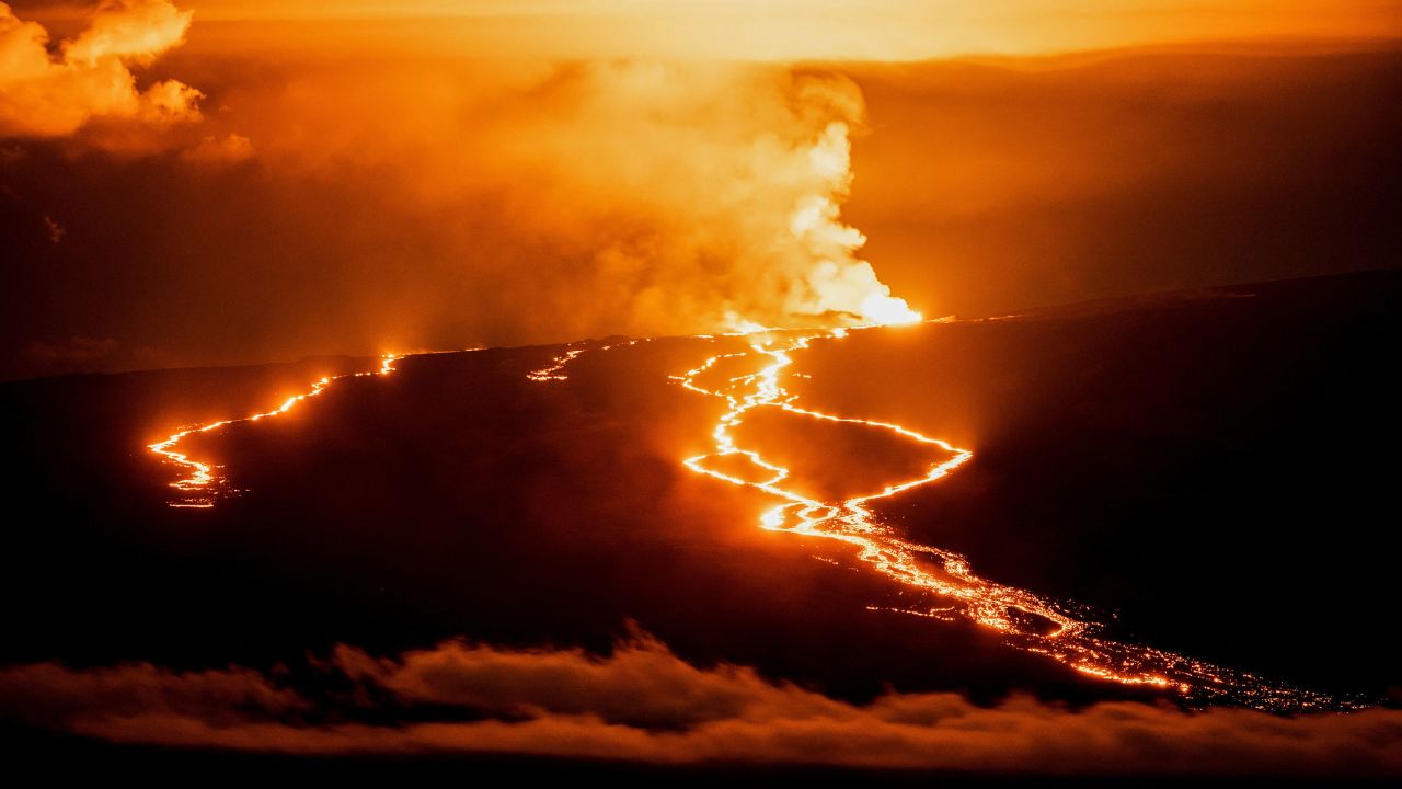 Lava fountains and flows illuminate the Big Island near the Mauna Loa volcano Wednesday.