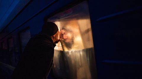 Georgiy Keburia says goodbye to his wife and children as they're on a train in Odesa, Ukraine. They were fleeing to the city of Lviv, in the country's west. The train station in Odesa had turned all its lights off to protect people from being targeted by the Russians. Salwan Georges/The Washington Post/Getty Images