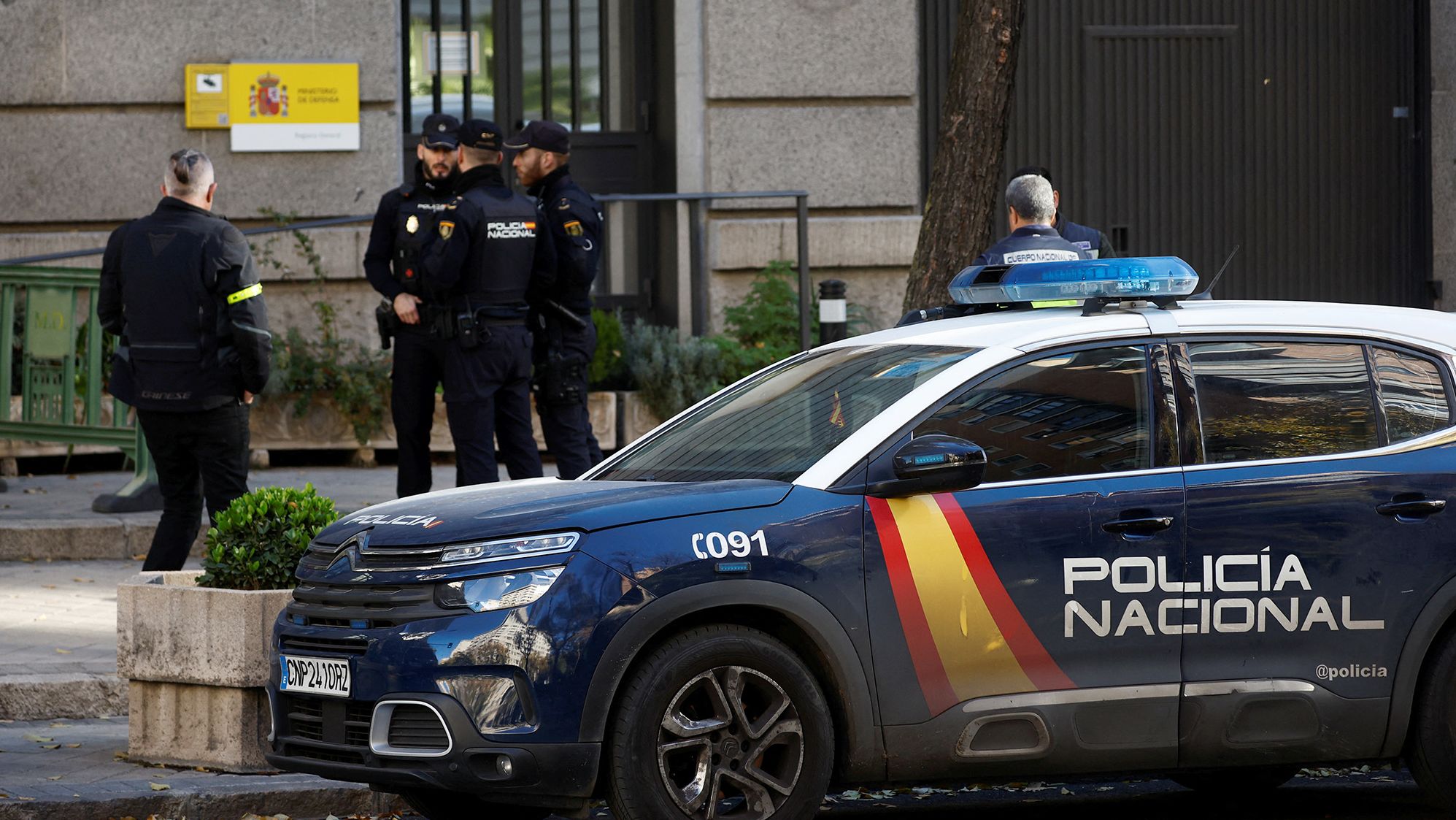 Police officers stand outside Spain's defense ministry after suspected explosive devices hidden in envelopes were mailed to the building, officials said.