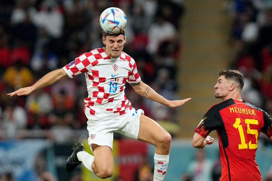 Croatia's Borna Sosa heads the ball near Belgium's Thomas Meunier.