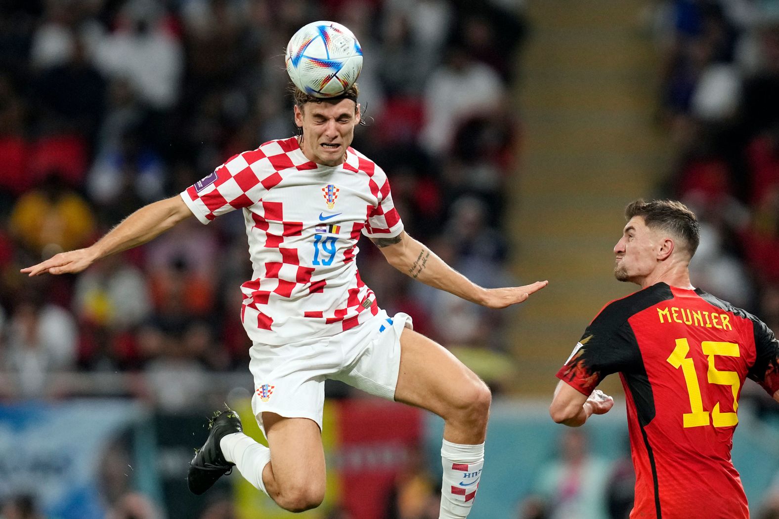 Croatia's Borna Sosa heads the ball near Belgium's Thomas Meunier.