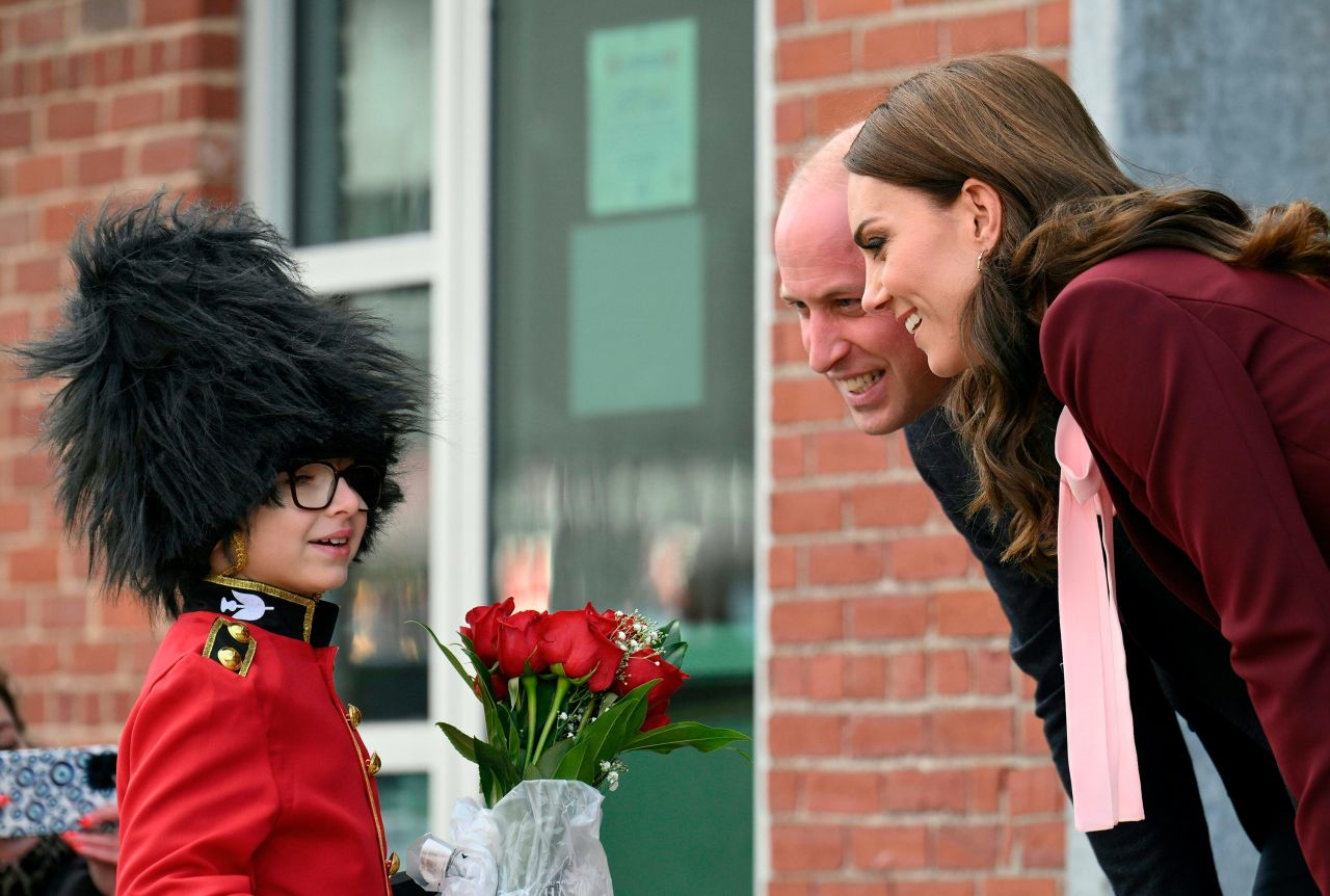 Henry Dynov-Teixeira, 8, presents flowers to the royal couple during their visit Thursday to Greentown Labs in Somerville, Massachusetts.