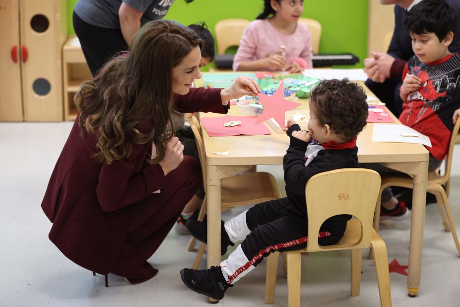 Kate talks to a child Thursday while visiting Roca, a nonprofit organization.