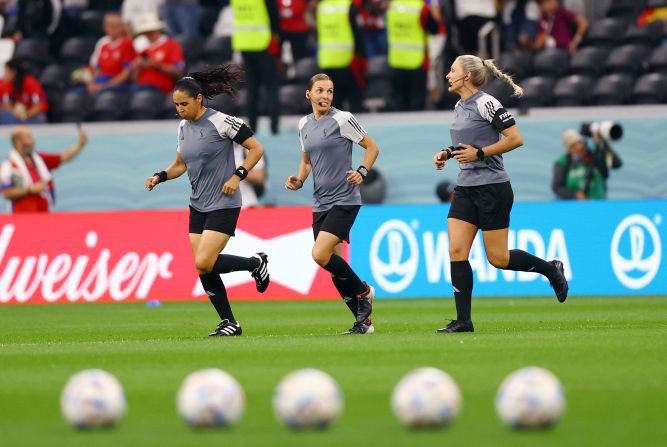 Referee Stephanie Frappart, center, warms up with assistant referees Karen Diaz, left, and Neuza Back before the Germany-Costa Rica match. <a href="index.php?page=&url=https%3A%2F%2Fwww.cnn.com%2Fsport%2Flive-news%2Fworld-cup-2022-12-01-2022%2Fh_9e54a9b7b64fac9df31c09b2f48fcc93" target="_blank">They made history</a> as the first all-female refereeing crew for a men's World Cup match. Frappert became the first woman to referee a men's World Cup match.
