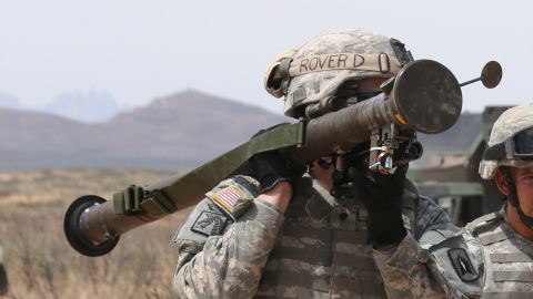 Florida Guardsmen from 3rd Battalion, 265th Air Defense Artillery Regiment, carry a shoulder mounted stinger missile launcher as they head to the firing lane at McGregor Range, N.M.