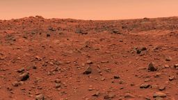 This color picture of Mars was taken July 21--the day following Viking l's successful landing on the planet. The local time on Mars is approximately noon. The view is southeast from the Viking. Orange-red surface materials cover most of the surface, apparently forming a thin veneer over darker bedrock exposed in patches, as in the lower right. The reddish surface materials may be limonite (hydrated ferric oxide). Such weathering products form on Earth in the presence of water and an oxidizing atmosphere. The sky has a reddish cast, probably due to scattering and reflection from reddish sediment suspended in the lower atmosphere. The scene was scanned three times by the spacecraft's camera number 2, through a different color filter each time. To assist in balancing the colors, a second picture was taken of z test chart mounted on the rear of the spacecraft. Color data for these patches were adjusted until the patches were an appropriate color of gray. The same calibration was then used for the entire scene.