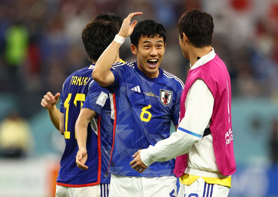 Wataru Endo celebrates with teammates after Japan qualified for the knockout stages of the World Cup. 