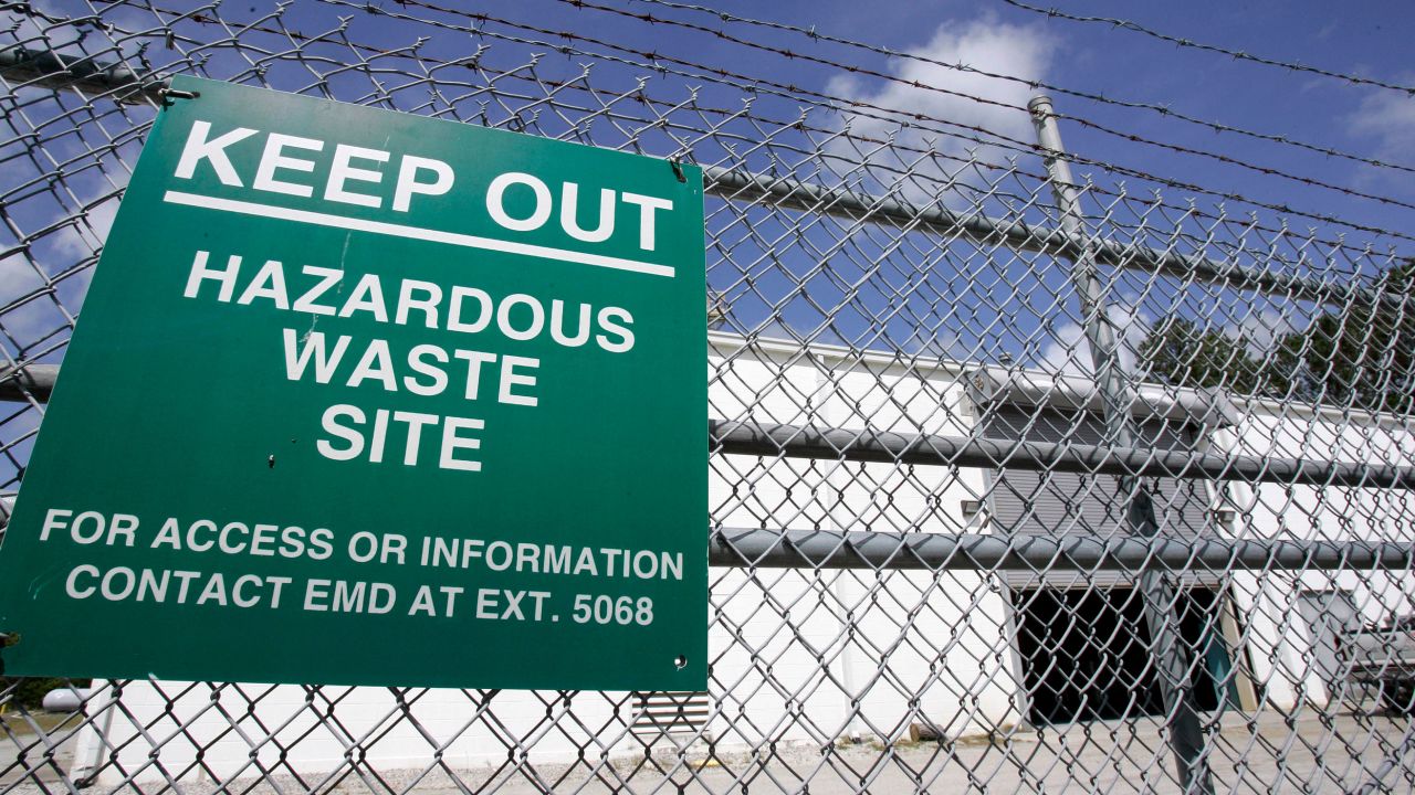 In this May 9, 2007, file photo, a sign is posted at an ongoing cleanup pump and treatment center operated by Shaw Corp. on lot 203 at Camp Lejeune, North Carolina, to treat the underground plume of TCE, trichloroethylene, created by a waste disposal site on the Marine base.