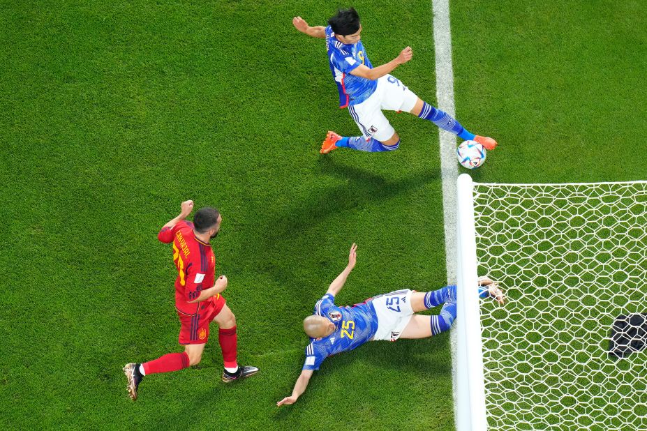 Japan's Kaoru Mitoma passes the ball near the goal line, leading to a goal <a href="index.php?page=&url=https%3A%2F%2Fwww.cnn.com%2Fsport%2Flive-news%2Fworld-cup-2022-12-01-2022%2Fh_e4ab2ec63f6820b9a3c4924c34bc0f36" target="_blank">that was upheld by a video assistant referee (VAR) review</a> during the match against Spain on December 1. Japan took a 2-1 lead and held on to win by that score. It finished first in Group E while Spain finished second.