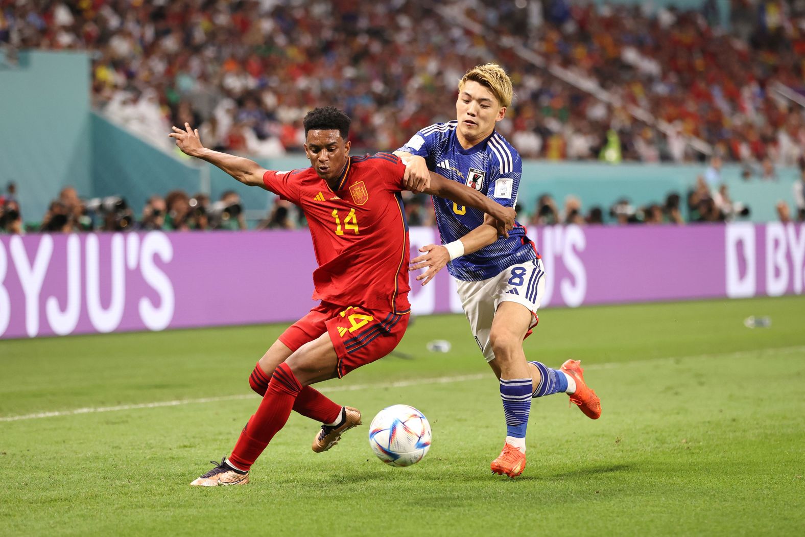 Spain's Alejandro Balde tries to hold up Japan's Ritsu Doan.