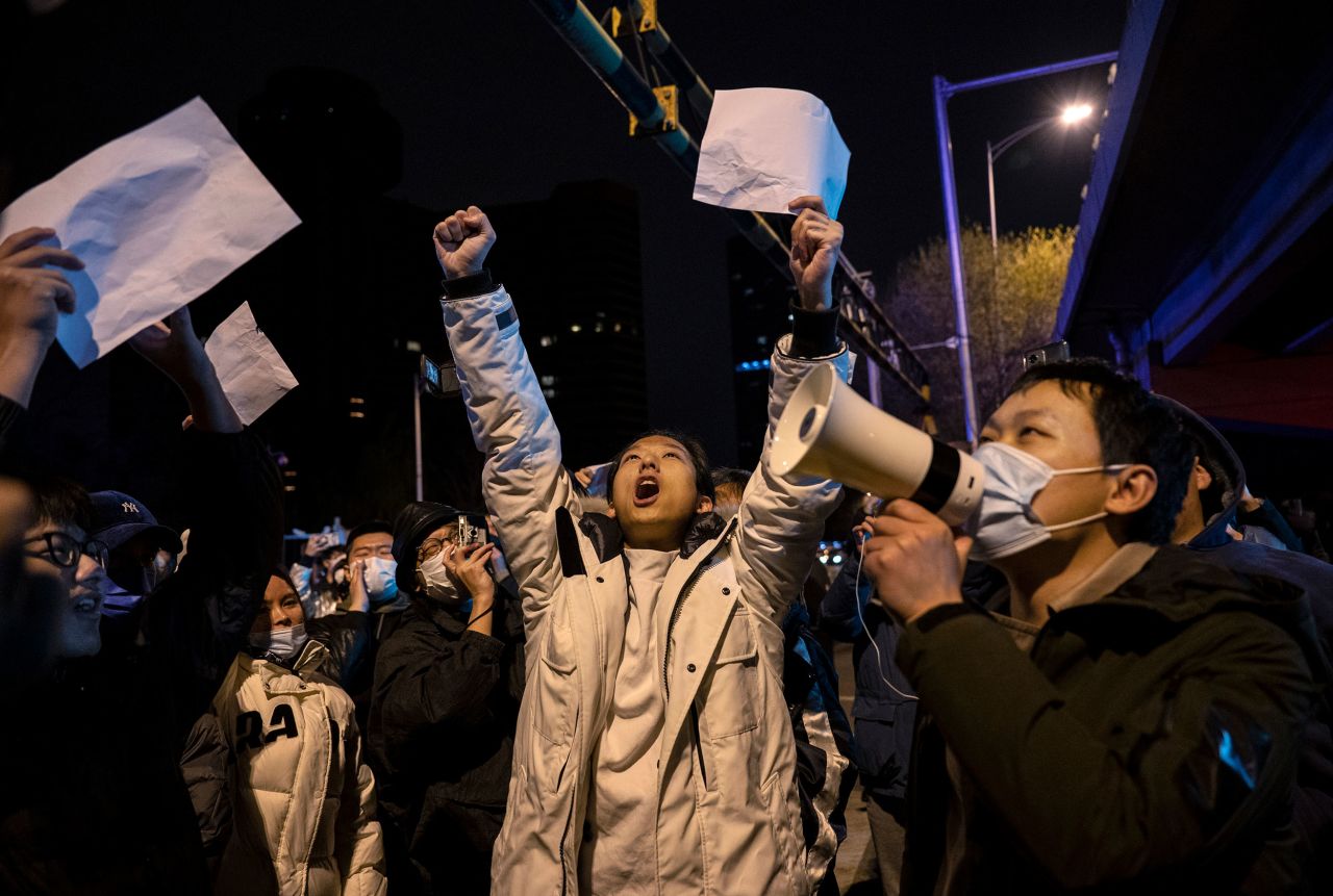 People in Beijing shout slogans on Monday, November 28, as they protest China's strict Covid-19 restrictions. <a href="https://www.cnn.com/2022/11/26/china/china-protests-xinjiang-fire-shanghai-intl-hnk/index.html" target="_blank">Unprecedented protests swept through China</a>, triggered by a deadly fire in Urumqi, the capital of the far western region of Xinjiang. Videos of <a href="https://www.cnn.com/2022/12/01/china/china-protests-lockdown-softening-covid-explainer-intl-hnk" target="_blank">the incident</a> appeared to show that lockdown measures had delayed firefighters from reaching the victims. The protests in China often featured demonstrators holding pieces of <a href="https://www.cnn.com/2022/11/29/economy/china-white-paper-protests-stock-run-intl-hnk" target="_blank">blank white paper</a>, a symbolic protest against censorship.
