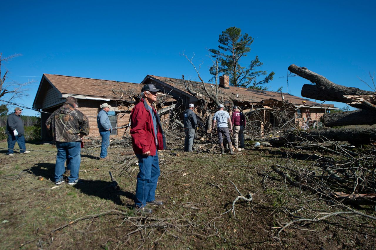 Robert Burdine, foreground, gets a first look at his storm-damaged property in Choctaw County, Mississippi, on Wednesday, November 30. <a href="https://www.cnn.com/2022/11/30/weather/tornadoes-severe-storms-south-wednesday/index.html" target="_blank">Severe storms and tornadoes</a> swept through parts of the South.