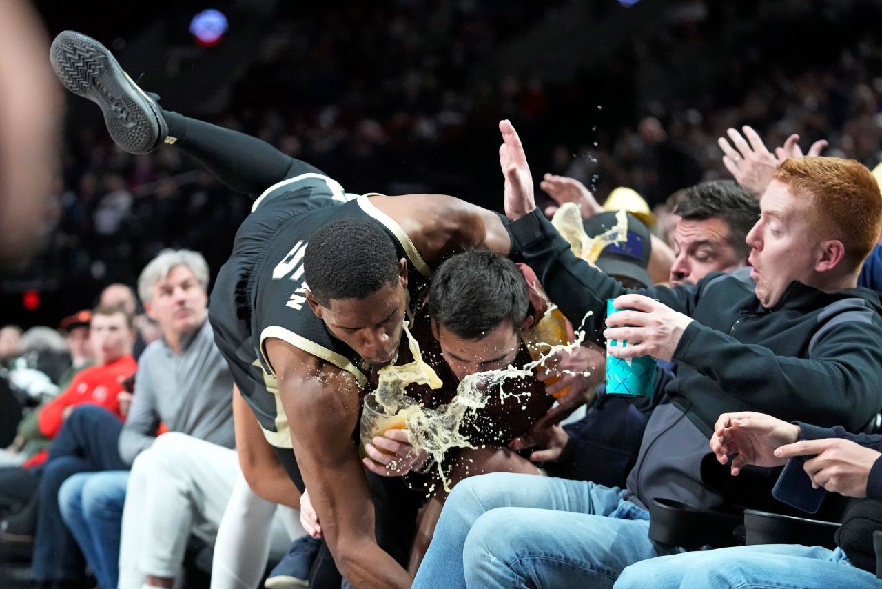 Purdue's Brandon Newman falls into the first row of fans during a college basketball game in Portland, Oregon, on Friday, November 25.