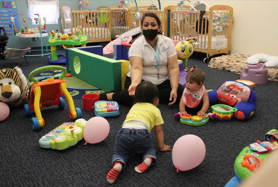 Teacher Graciela Olague-Barrios works with infants in 2021 at Cuidando Los Ninos in Albuquerque, New Mexico.