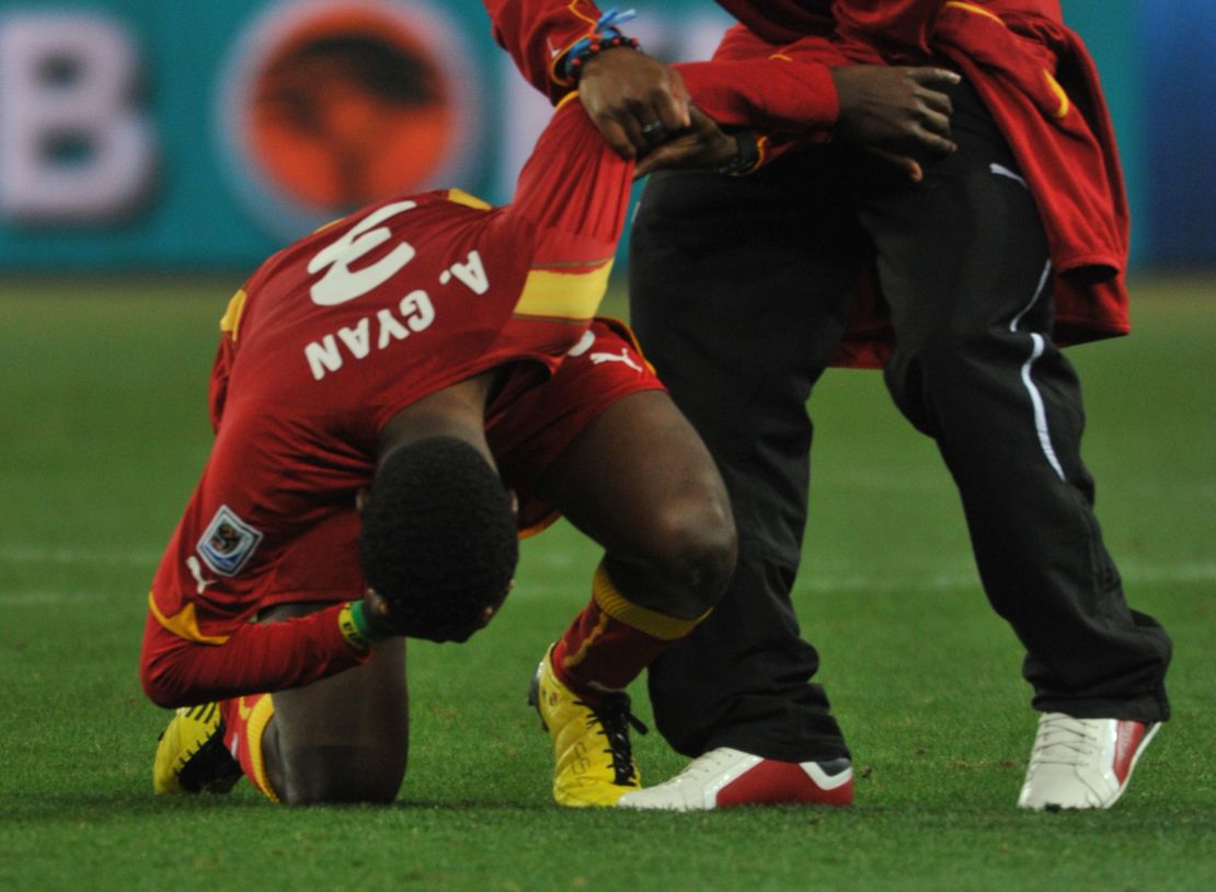 Asamoah Gyan is consoled following the penalty shootout defeat in 2010.