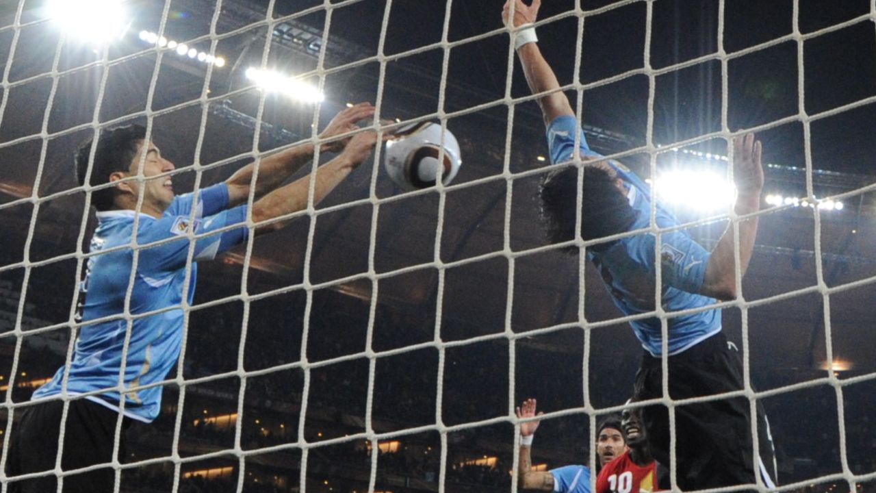 Luis Suárez blocks the shot on the line with his hands.