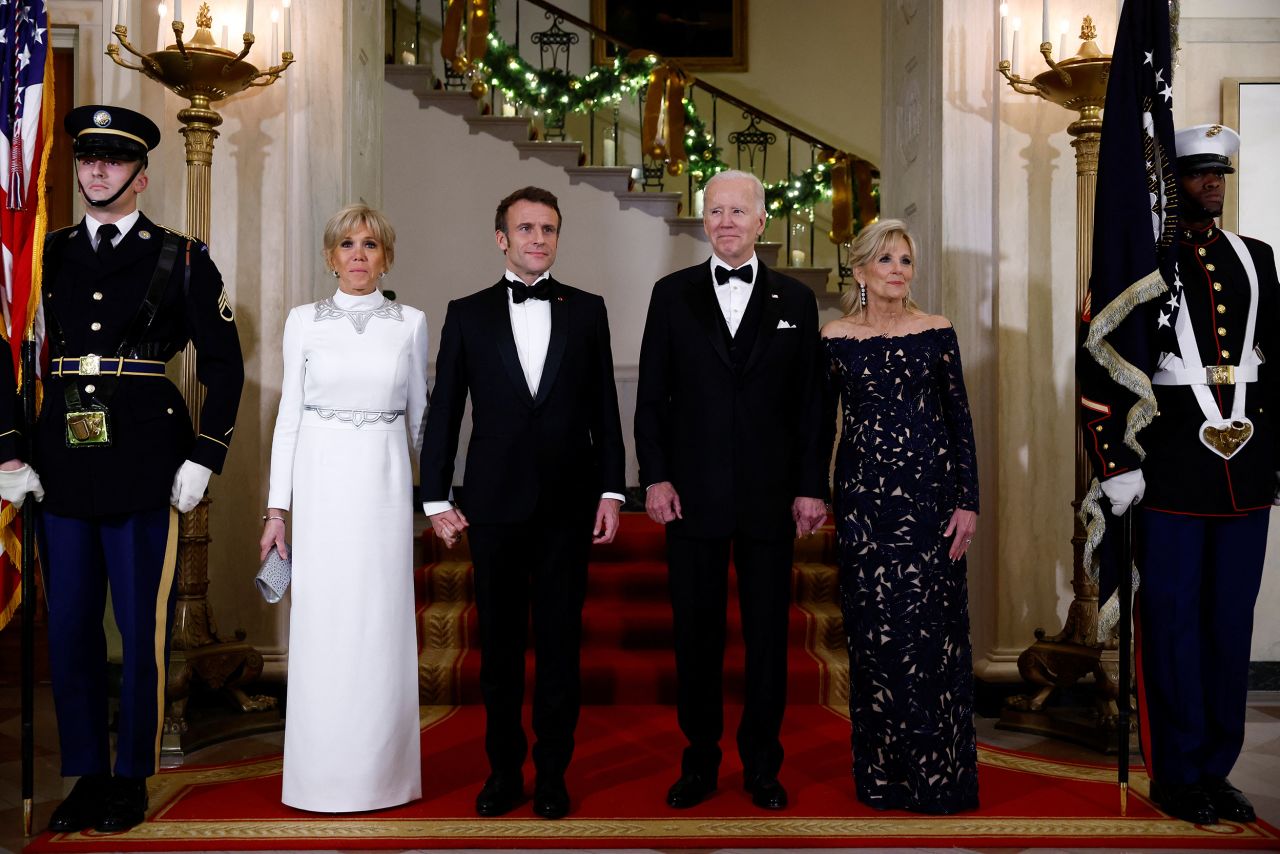 The Bidens and Macrons pose for a picture at the Grand Staircase of the White House.