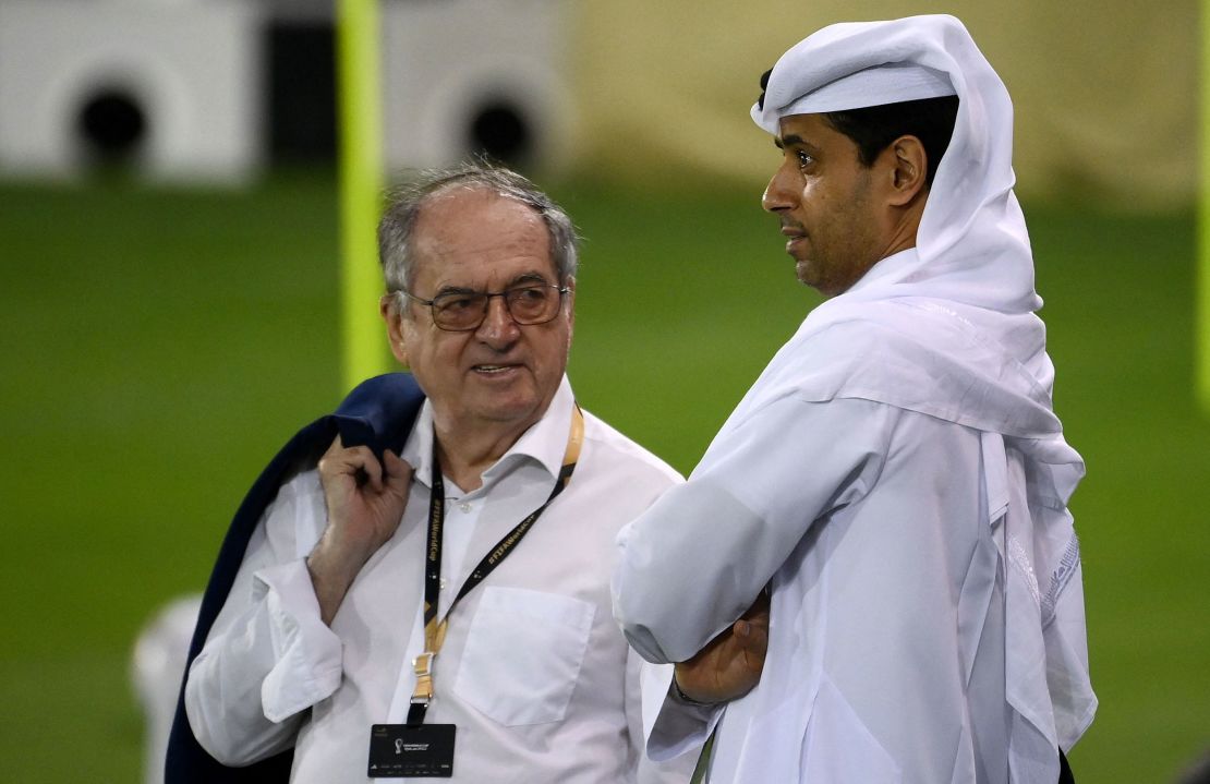 The head of the French Football Federation, Noel Le Graet (L) speaks with  Paris Saint-Germain's Nasser Al-Khelaifi during France's training session at the Jassim-bin-Hamad Stadium in Doha on November 17, 2022, ahead of Qatar 2022.