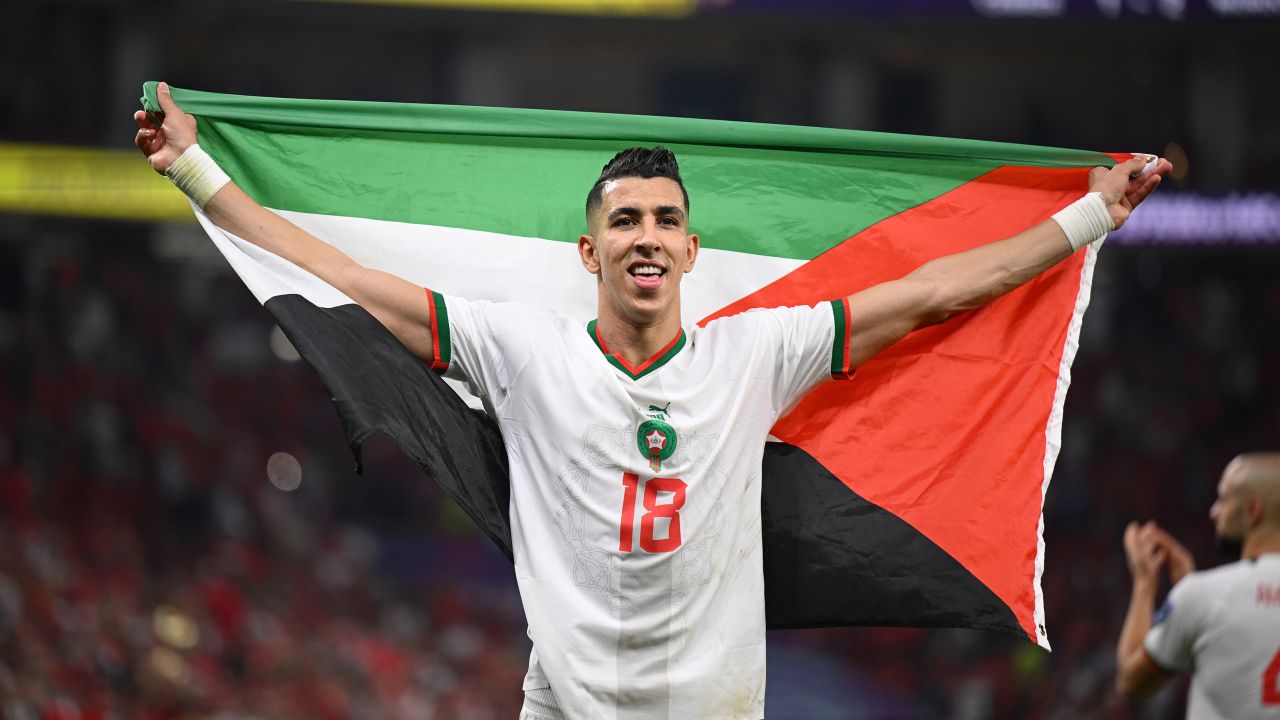 Jawad El Yamiq of Morocco celebrates with a Palestinian flag after his team qualified for the World Cup knockout stages after beating Canada on Thursday in Doha, Qatar.