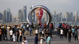 People gather around the official countdown clock showing remaining time until the kick-off of the World Cup 2022, in Doha, Qatar, Friday, Nov. 11.