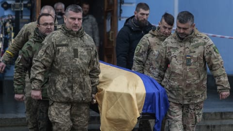 KYIV, UKRAINE - NOVEMBER 26: The coffin of Valeriy Krasnyan "Bars" is brought out of St. Michael's Golden-Domed Monastery on November 26, 2022 in Kyiv, Ukraine. A defender of the Donetsk airport, he returned to Ukraine to join the ranks of the Armed Forces after the Russian Invasion began, he was killed on November 24th by a land mine. (Photo by Jeff J Mitchell/Getty Images)