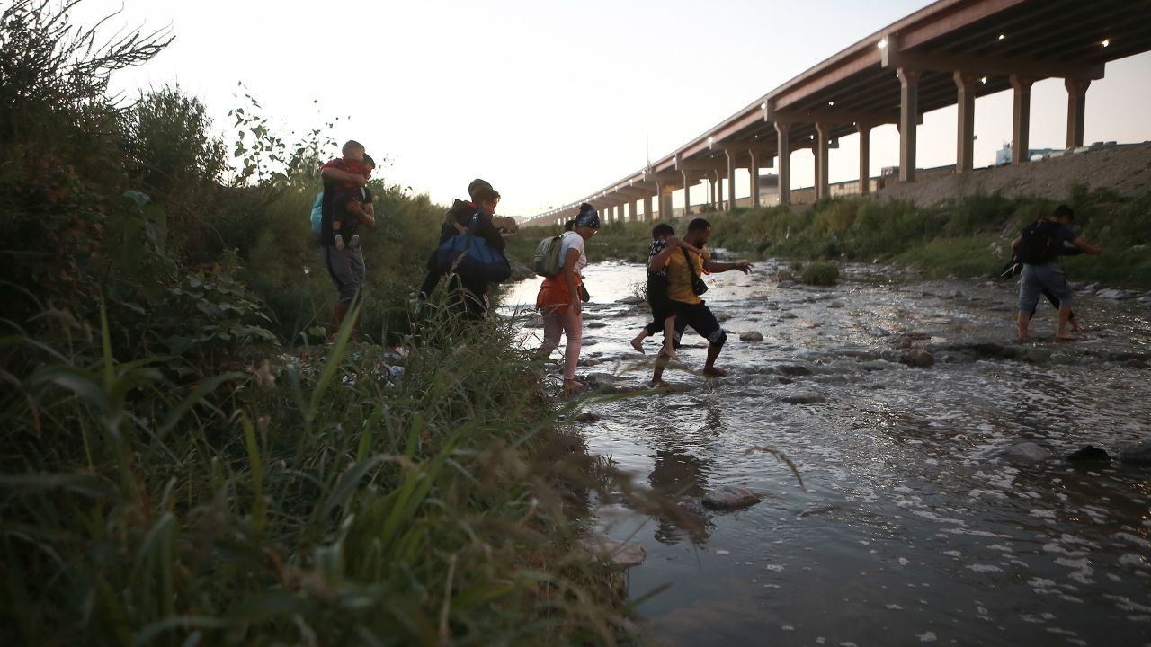 Venezuelan migrants walk across the Rio Bravo toward the United States border from Ciudad Juarez, Mexico, on October 13, 2022.