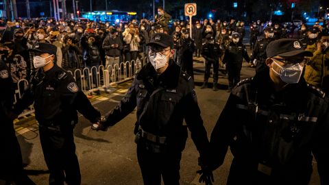Police form a cordon  during a protest in Beijing on November 27.