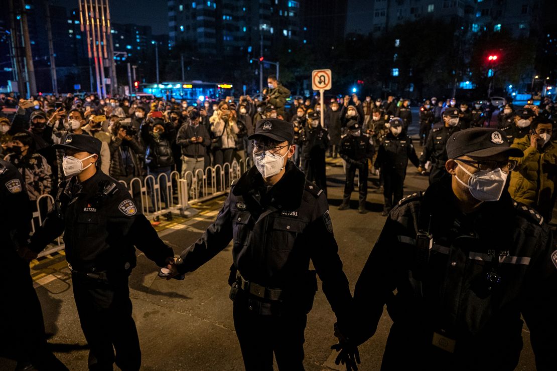 Police form a cordon  during a protest in Beijing on November 27.