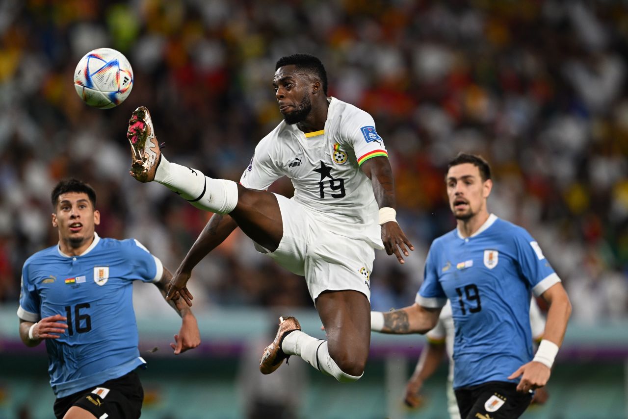 Ghana's Inaki Williams leaps for a kick against Uruguay.