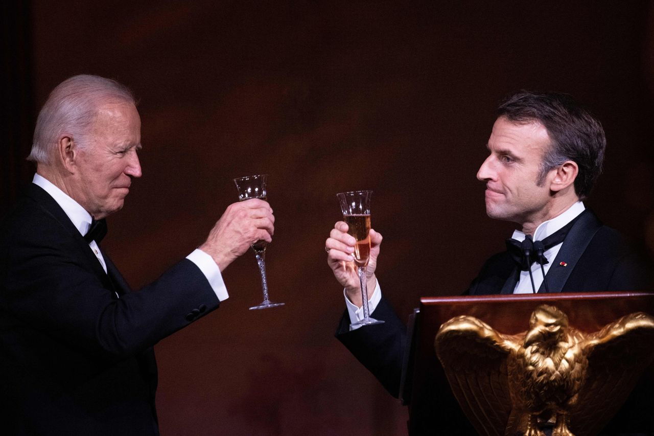 Macron and Biden share a toast during the dinner.